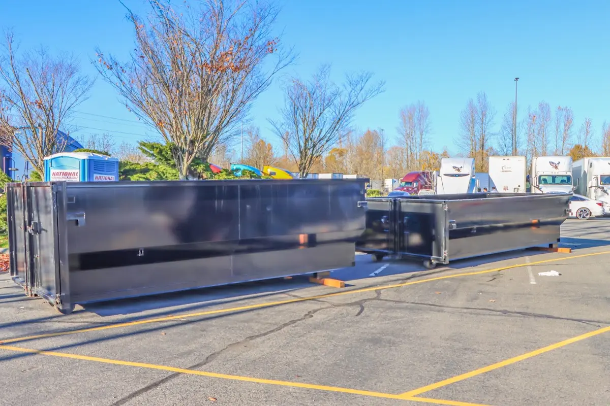 Professional dumpster rental service with roll-off container on residential driveway in Bexley